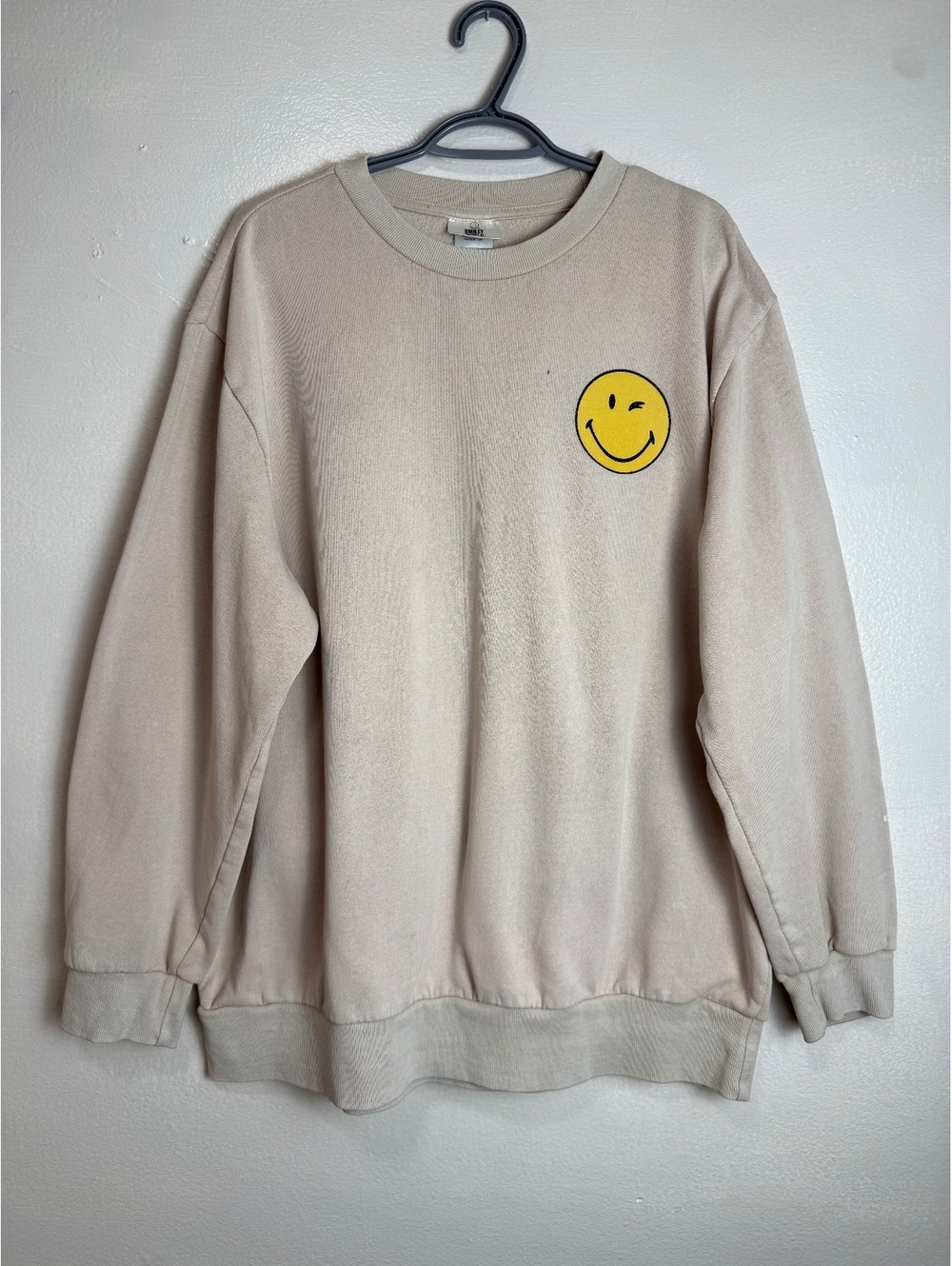 SmileyWorld Beige Sweatshirt with Winking Smiley Face and Live Happy Print
